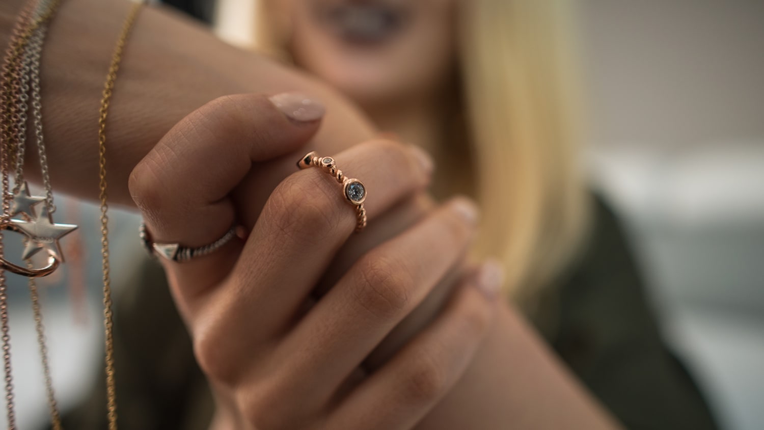Woman showing elegant gold ring with gemstone